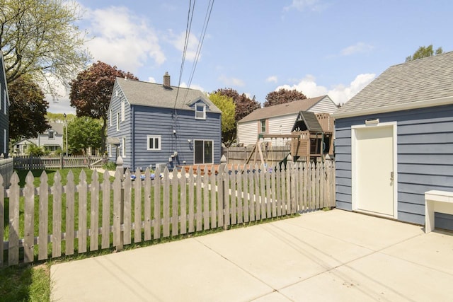3552 S Pine Ave, Milwaukee, WI 53207 - back of house with a patio area, a chimney, and roof with shingles