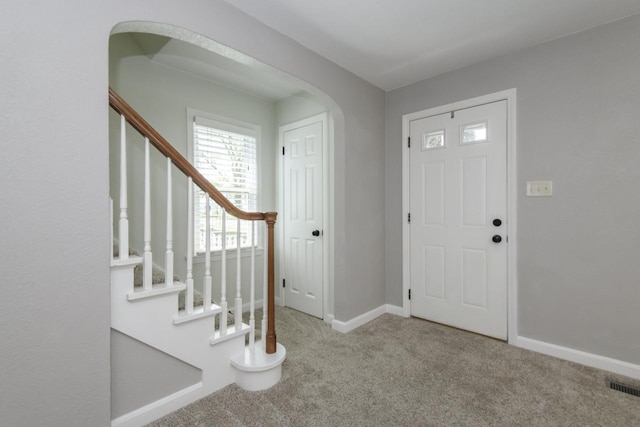 3552 S Pine Ave, Milwaukee, WI 53207 - entryway with carpet floors, baseboards, stairway, and arched walkways