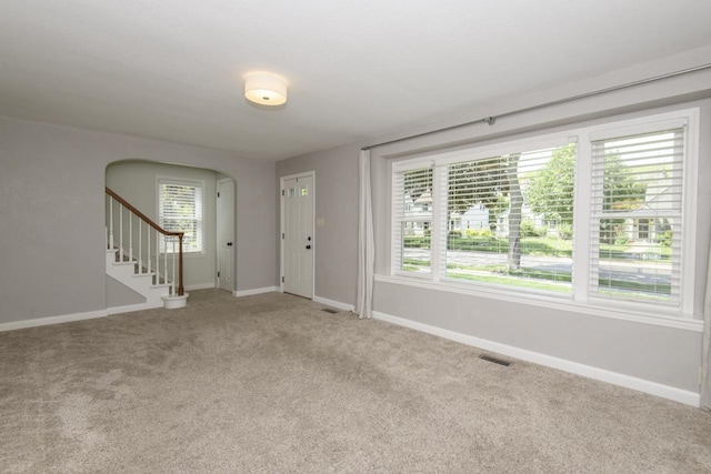 3552 S Pine Ave, Milwaukee, WI 53207 - entryway with baseboards, light carpet, arched walkways, and stairs