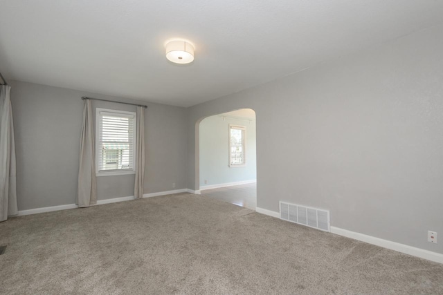 3552 S Pine Ave, Milwaukee, WI 53207 - empty room featuring arched walkways, carpet floors, and baseboards