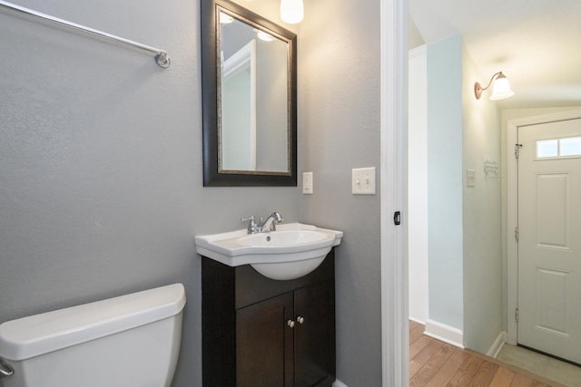 3552 S Pine Ave, Milwaukee, WI 53207 - half bath with vanity, toilet, wood finished floors, and baseboards