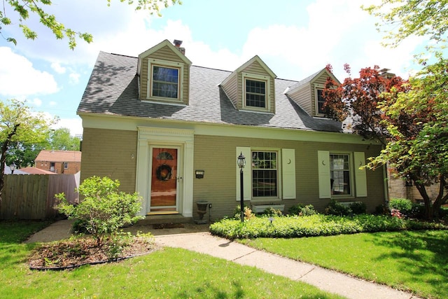116 N 85th St, Wauwatosa, WI 53226 - cape cod house featuring a chimney, brick siding, and a shingled roof