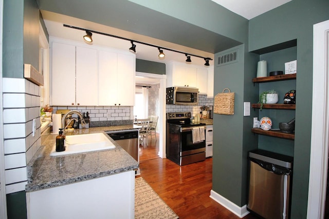 116 N 85th St, Wauwatosa, WI 53226 - kitchen with stainless steel appliances, a sink, rail lighting, and white cabinetry
