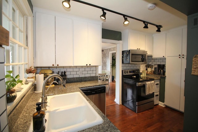 116 N 85th St, Wauwatosa, WI 53226 - kitchen featuring stainless steel appliances, a sink, decorative backsplash, and dark wood-style floors