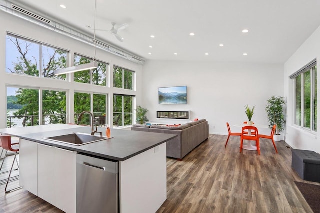 303 Craig Rd, Edgerton, WI 53534 - kitchen with stainless steel dishwasher, white cabinetry, recessed lighting, dark wood-style floors, and a center island with sink