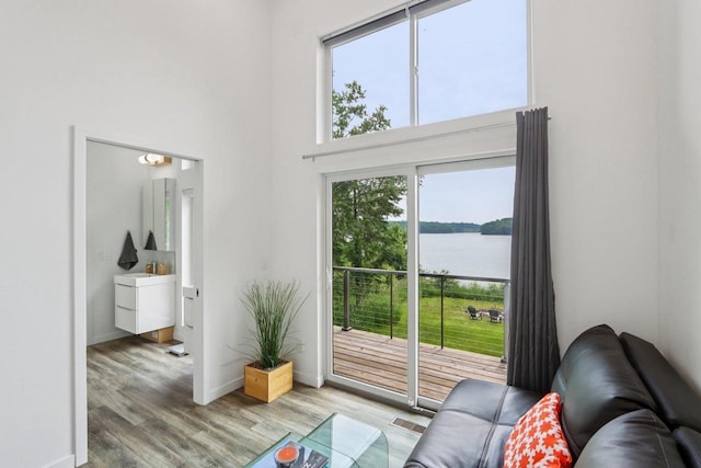 303 Craig Rd, Edgerton, WI 53534 - living room featuring wood finished floors, a water view, and a high ceiling