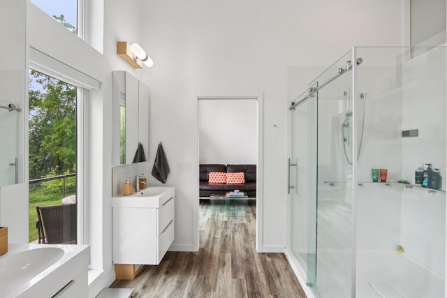 303 Craig Rd, Edgerton, WI 53534 - full bath featuring a stall shower, wood finished floors, and two vanities