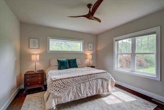 5508 Midmoor Rd, Monona, WI 53716 - bedroom featuring multiple windows, baseboards, and dark wood-type flooring