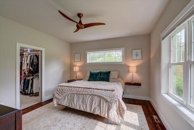 5508 Midmoor Rd, Monona, WI 53716 - bedroom featuring a closet, baseboards, wood finished floors, ceiling fan, and a walk in closet