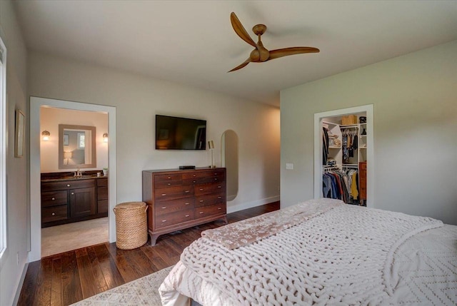 5508 Midmoor Rd, Monona, WI 53716 - bedroom with dark wood-style flooring, a sink, a spacious closet, arched walkways, and a closet