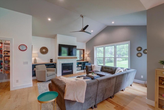 5508 Midmoor Rd, Monona, WI 53716 - living room with a ceiling fan, light wood-type flooring, a glass covered fireplace, high vaulted ceiling, and baseboards