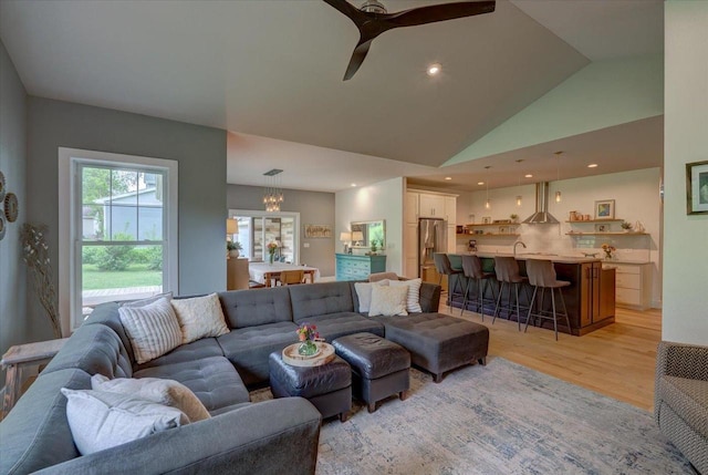 5508 Midmoor Rd, Monona, WI 53716 - living room featuring light wood-style flooring, lofted ceiling, ceiling fan, a chandelier, and recessed lighting