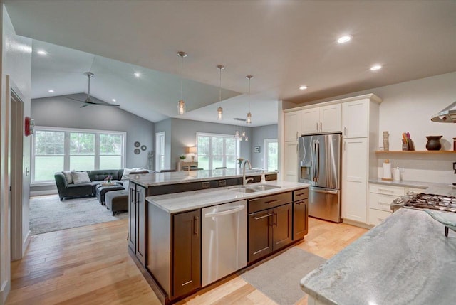 5508 Midmoor Rd, Monona, WI 53716 - kitchen with appliances with stainless steel finishes, a sink, open floor plan, light wood-style flooring, and a center island with sink