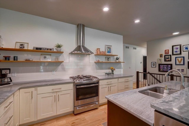 5508 Midmoor Rd, Monona, WI 53716 - kitchen featuring stainless steel gas range, a sink, wall chimney range hood, open shelves, and light wood-style flooring