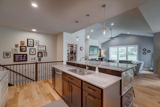 5508 Midmoor Rd, Monona, WI 53716 - kitchen featuring a sink, appliances with stainless steel finishes, open floor plan, a kitchen island with sink, and light wood-type flooring
