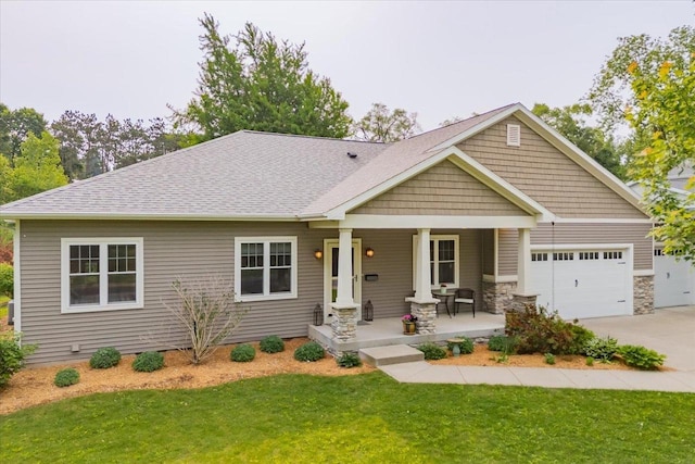 5508 Midmoor Rd, Monona, WI 53716 - craftsman-style home with covered porch, concrete driveway, a front yard, an attached garage, and roof with shingles