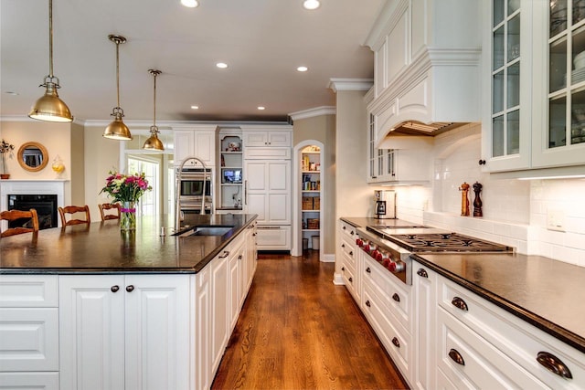1834 Camelot Dr, Madison, WI 53705 - kitchen featuring dark countertops, a sink, crown molding, stainless steel gas cooktop, and backsplash