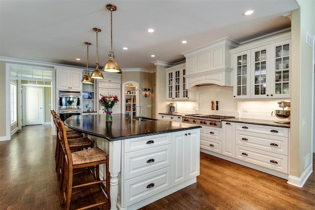 1834 Camelot Dr, Madison, WI 53705 - kitchen with a sink, stainless steel appliances, dark countertops, tasteful backsplash, and ornamental molding