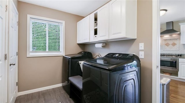 1604 Lake Rd, Altoona, WI 54720 - laundry area with cabinet space, independent washer and dryer, dark wood-style floors, and baseboards