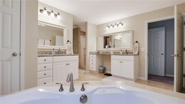 1604 Lake Rd, Altoona, WI 54720 - full bathroom with vanity, tile patterned flooring, a tub to relax in, and baseboards