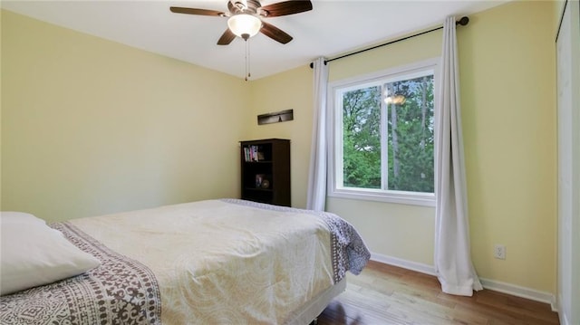 1604 Lake Rd, Altoona, WI 54720 - bedroom featuring wood finished floors, baseboards, and ceiling fan