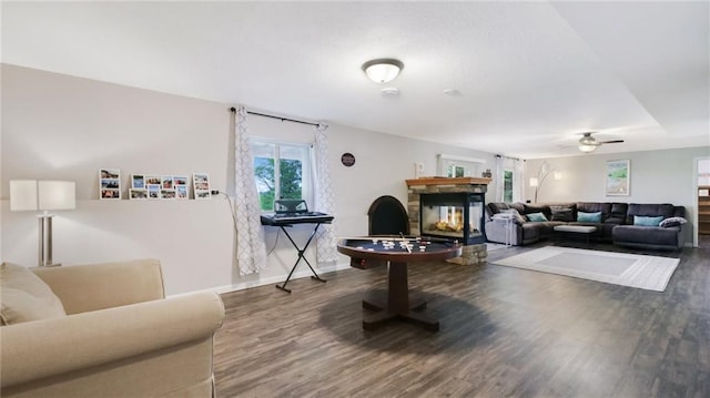 1604 Lake Rd, Altoona, WI 54720 - living area with a stone fireplace, wood finished floors, a ceiling fan, and baseboards
