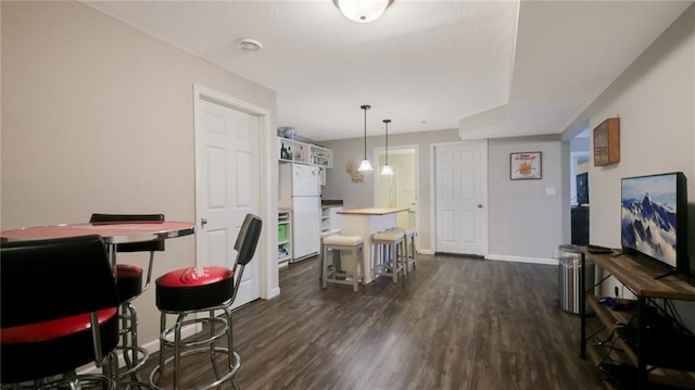 1604 Lake Rd, Altoona, WI 54720 - dining space featuring dark wood-style flooring and baseboards