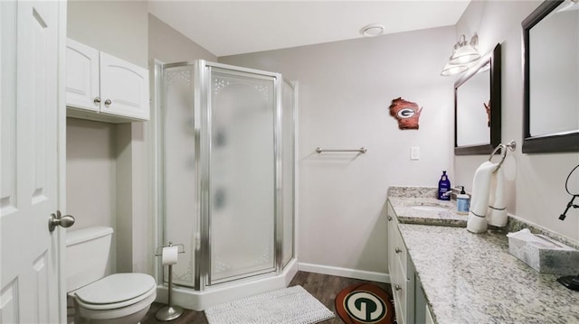 1604 Lake Rd, Altoona, WI 54720 - full bathroom with vanity, toilet, a shower stall, and baseboards