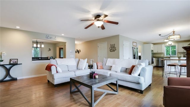 1604 Lake Rd, Altoona, WI 54720 - living area featuring a ceiling fan, wood finished floors, recessed lighting, a chandelier, and baseboards