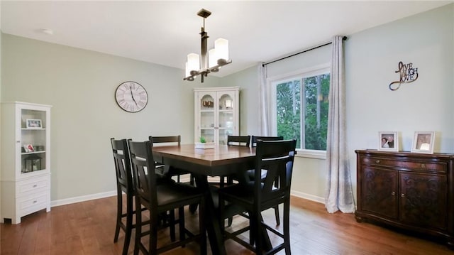 1604 Lake Rd, Altoona, WI 54720 - dining room featuring wood finished floors, a chandelier, and baseboards