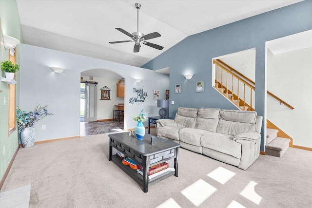 1110 Stillmeadow Ln, Menasha, WI 54952 - carpeted living room featuring arched walkways, lofted ceiling, a ceiling fan, stairway, and baseboards
