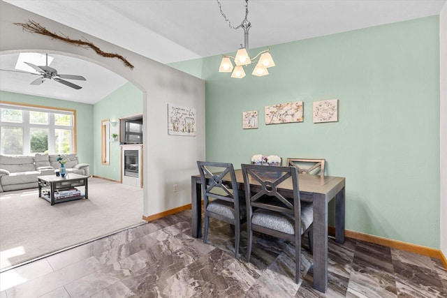 1110 Stillmeadow Ln, Menasha, WI 54952 - dining space with arched walkways, baseboards, a ceiling fan, marble finish floors, and a chandelier