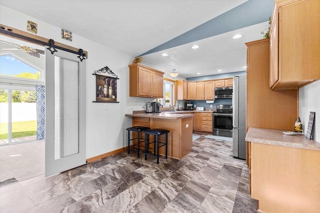 1110 Stillmeadow Ln, Menasha, WI 54952 - kitchen featuring appliances with stainless steel finishes, a peninsula, a sink, a barn door, and baseboards