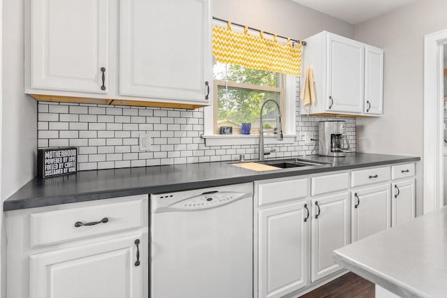813 W Summer St, Appleton, WI 54914 - kitchen featuring dishwasher, a sink, dark countertops, white cabinets, and decorative backsplash