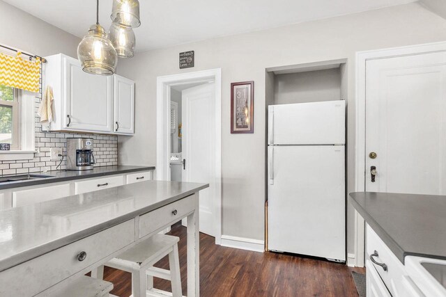 813 W Summer St, Appleton, WI 54914 - kitchen with freestanding refrigerator, dark countertops, white cabinets, decorative backsplash, and dark wood-style flooring