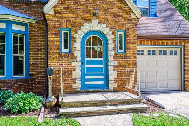 813 W Summer St, Appleton, WI 54914 - doorway to property featuring brick siding and a garage