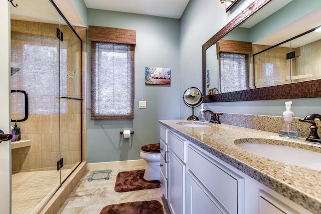 6679 S Chickahauk Trl, Middleton, WI 53562 - bathroom with toilet, double vanity, a stall shower, and baseboards