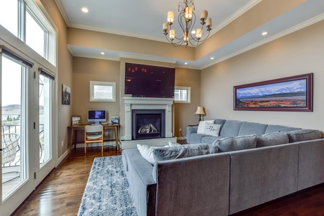 6679 S Chickahauk Trl, Middleton, WI 53562 - living area featuring healthy amount of natural light, dark wood-style floors, a glass covered fireplace, ornamental molding, and recessed lighting