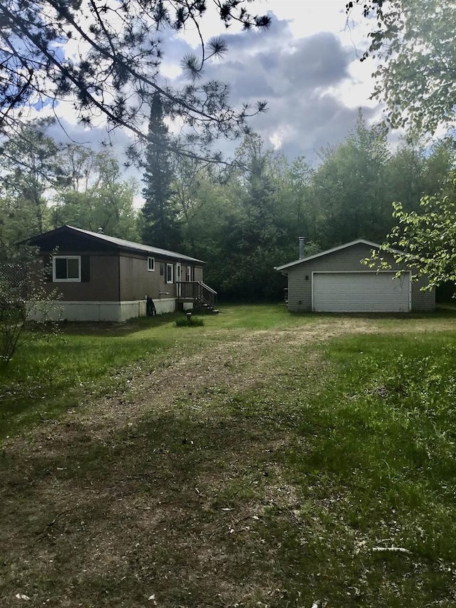 N7777 Kitty Dell Rd, Crivitz, WI 54114 - view of grassy yard with an outdoor structure, a garage, and driveway