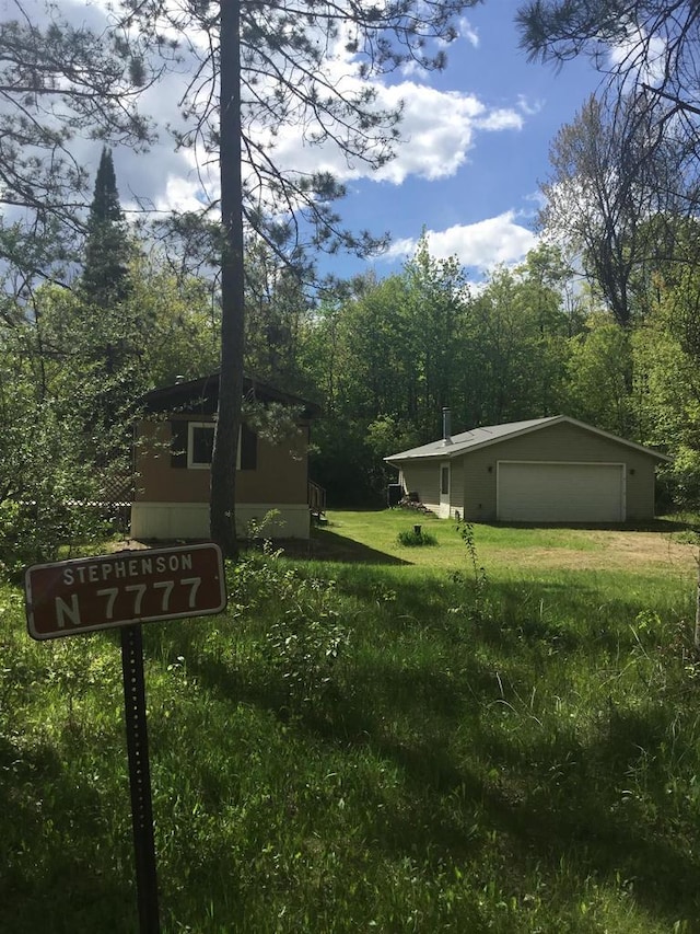N7777 Kitty Dell Rd, Crivitz, WI 54114 - view of green lawn featuring an outbuilding