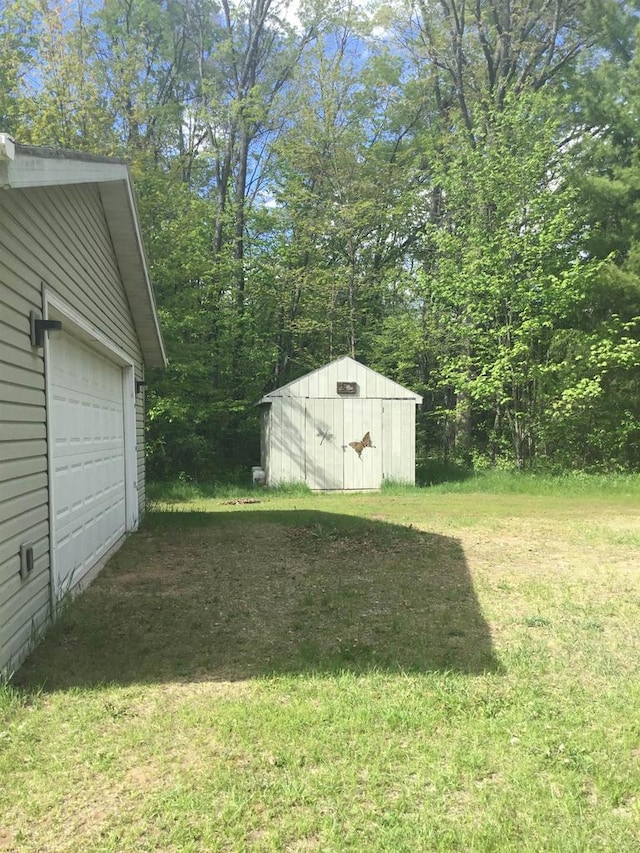 N7777 Kitty Dell Rd, Crivitz, WI 54114 - view of green lawn with an outbuilding and a garage