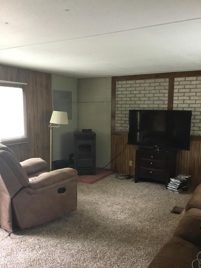 N7777 Kitty Dell Rd, Crivitz, WI 54114 - living room with wood walls, a wood stove, and carpet flooring
