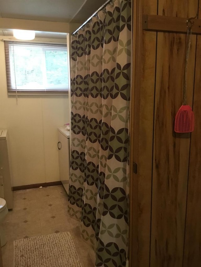 N7777 Kitty Dell Rd, Crivitz, WI 54114 - full bath with toilet, a shower with shower curtain, baseboards, and tile patterned floors