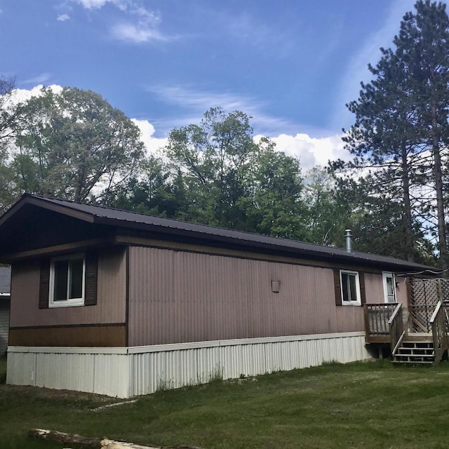 N7777 Kitty Dell Rd, Crivitz, WI 54114 - view of side of property with a wooden deck, a lawn, and metal roof