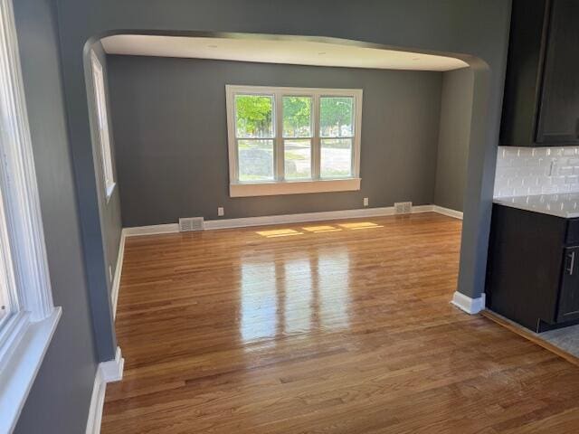 2254 W Roosevelt Dr, Milwaukee, WI 53209 - unfurnished room featuring arched walkways, wood finished floors, and baseboards