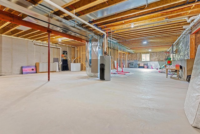 N994 N Rd, Hortonville, WI 54944 - basement featuring water heater, heating unit, and washer and clothes dryer