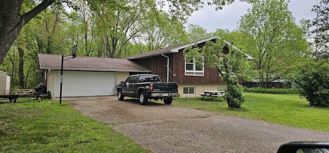 202 S Fandrich St, Oxford, WI 53952 - view of front of home with driveway, a front yard, brick siding, and an attached garage