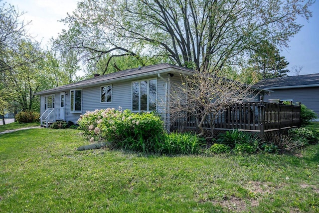 706 Tremont St, Mauston, WI 53948 - view of property exterior featuring a lawn and a wooden deck