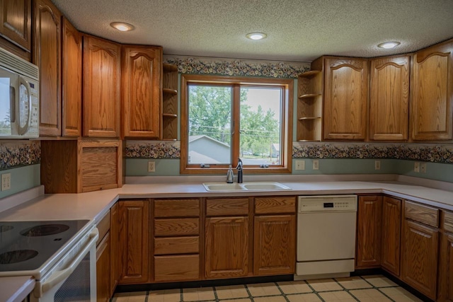 706 Tremont St, Mauston, WI 53948 - kitchen with white appliances, open shelves, a sink, brown cabinets, and a textured ceiling