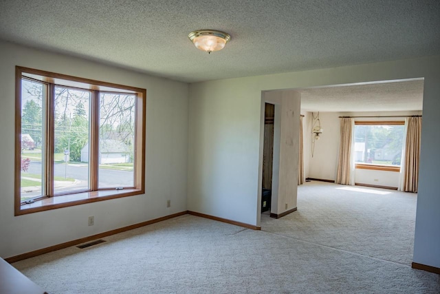706 Tremont St, Mauston, WI 53948 - carpeted spare room with baseboards and a textured ceiling